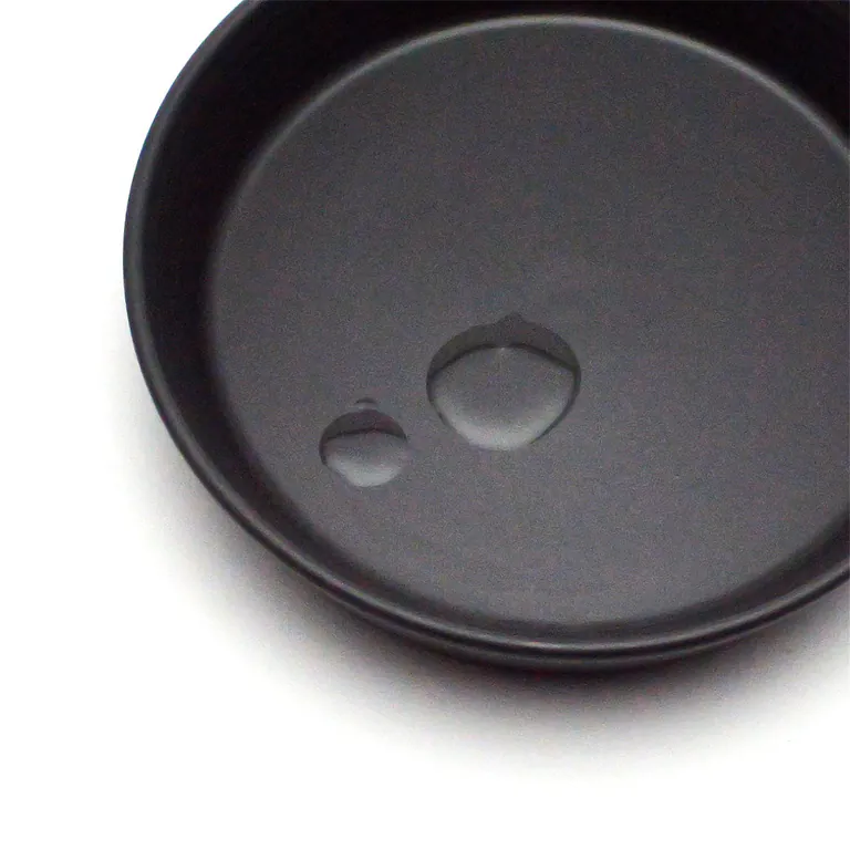 Two drops of Multi-Oil Serum in a dark dish
